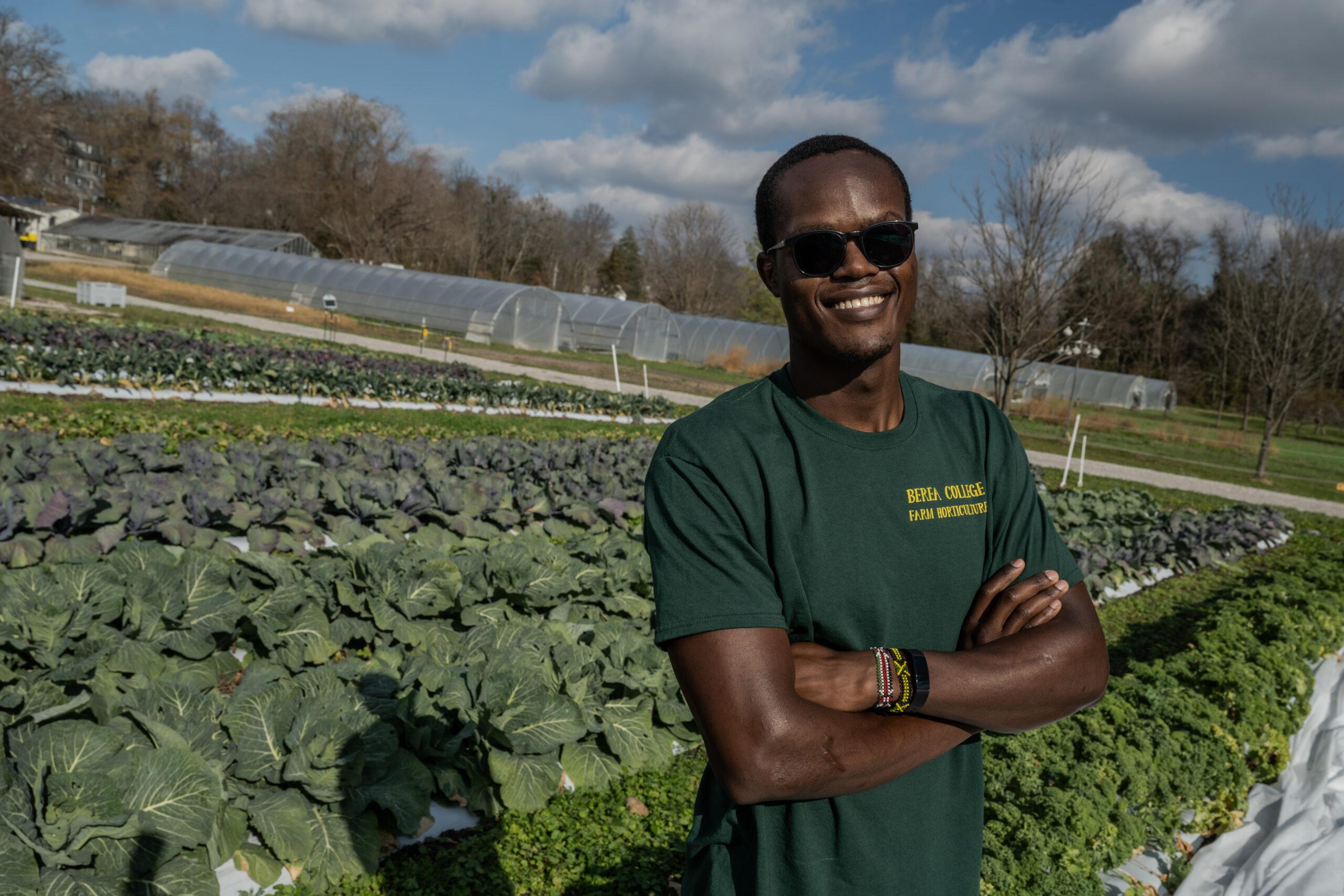 A Berea College student at the horticulture farm